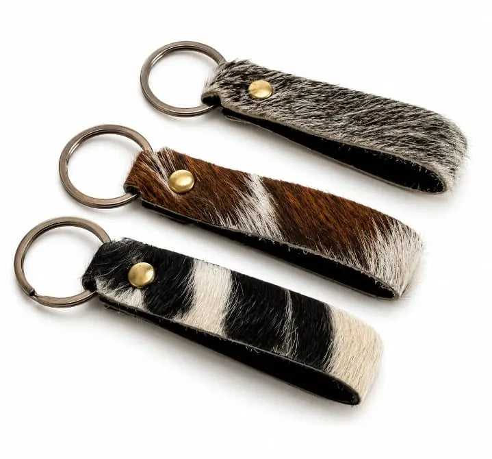 Rustic cowhide loop keychain straps with metal split rings in mixed natural patterns