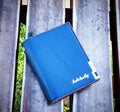 Men's bifold wallet with metal corner accent, ID window, card slots and cash storage