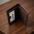 Men's bifold wallet with metal corner accent, ID window, card slots and cash storage